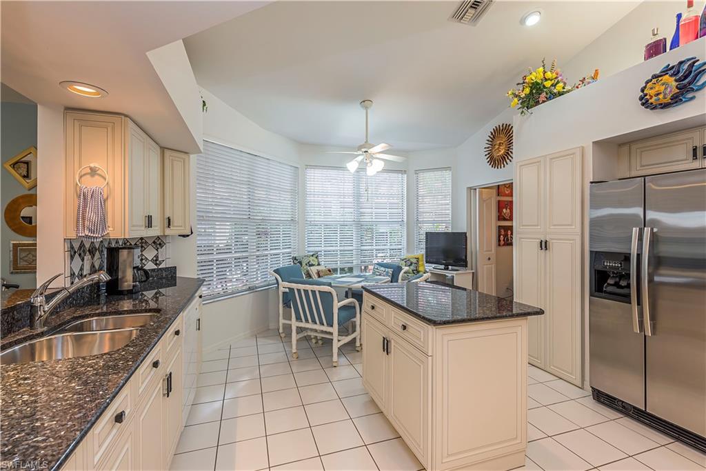 144 Napa Ridge Way Naples, FL 34119 - Photo 4 of 12 a kitchen with counter space cabinets and appliances