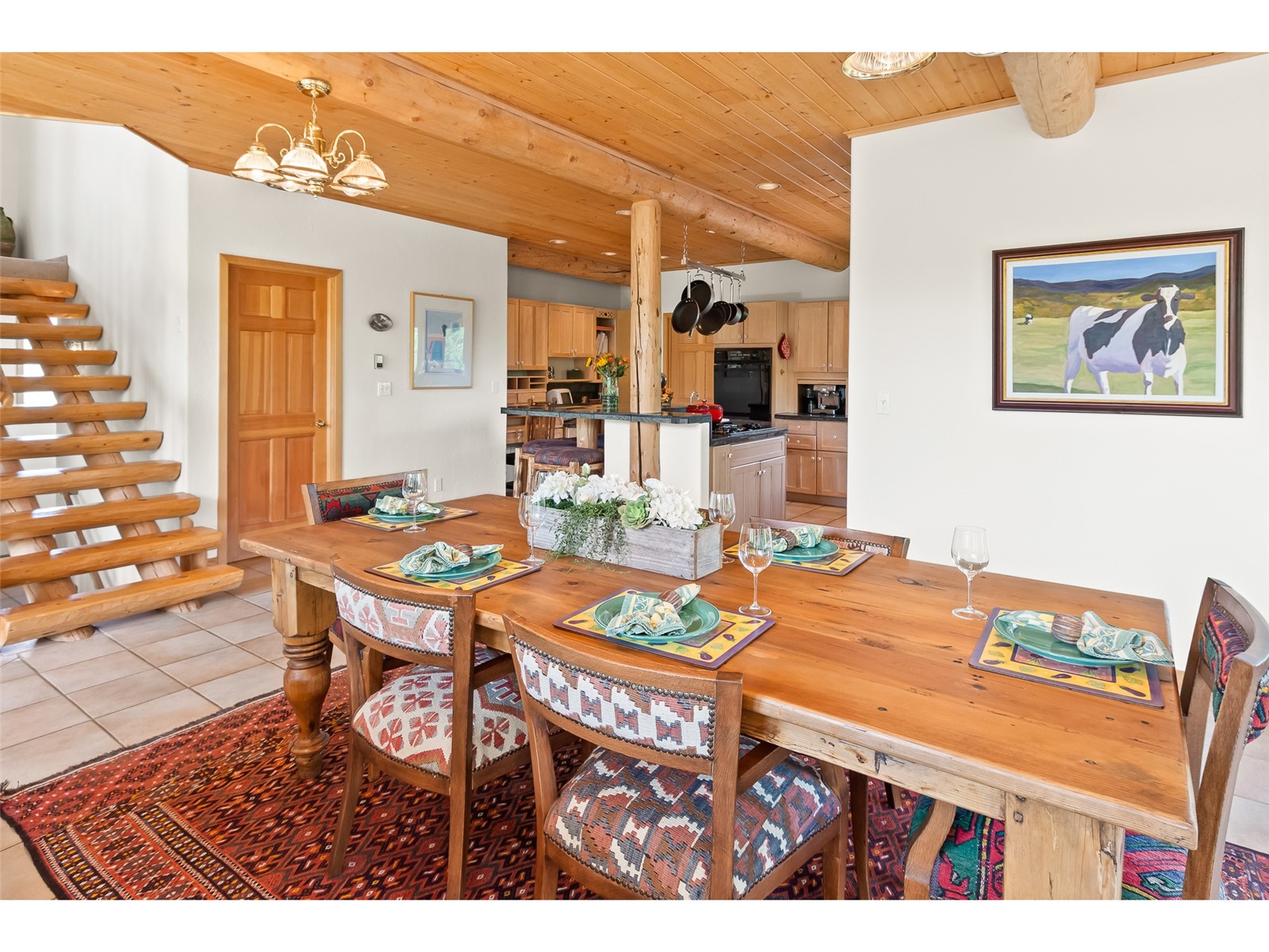 1746 South Ruby Road Silverthorne, CO 80498 - Photo 25 of 50 Dining room with wooden ceiling, beam ceiling, an inviting chandelier, and light tile floors