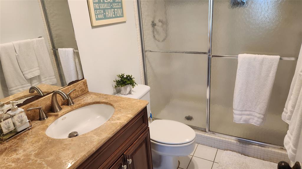 405 North Ocean Boulevard, Unit 1507 Pompano Beach, FL 33062 - Photo 14 of 19 a bathroom with a granite countertop sink toilet and shower