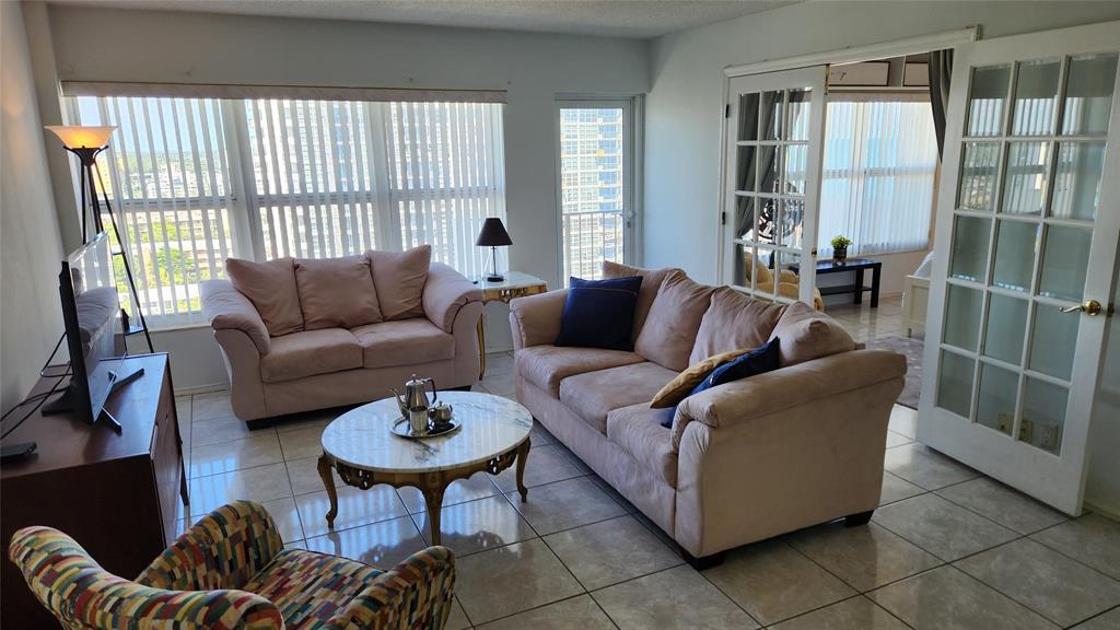 405 North Ocean Boulevard, Unit 1507 Pompano Beach, FL 33062 - Photo 5 of 19 a living room with furniture and a potted plant