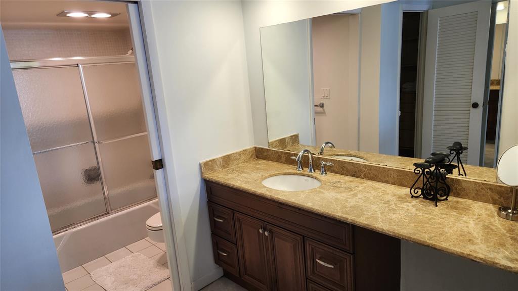 405 North Ocean Boulevard, Unit 1507 Pompano Beach, FL 33062 - Photo 8 of 19 a bathroom with a granite countertop sink and a mirror