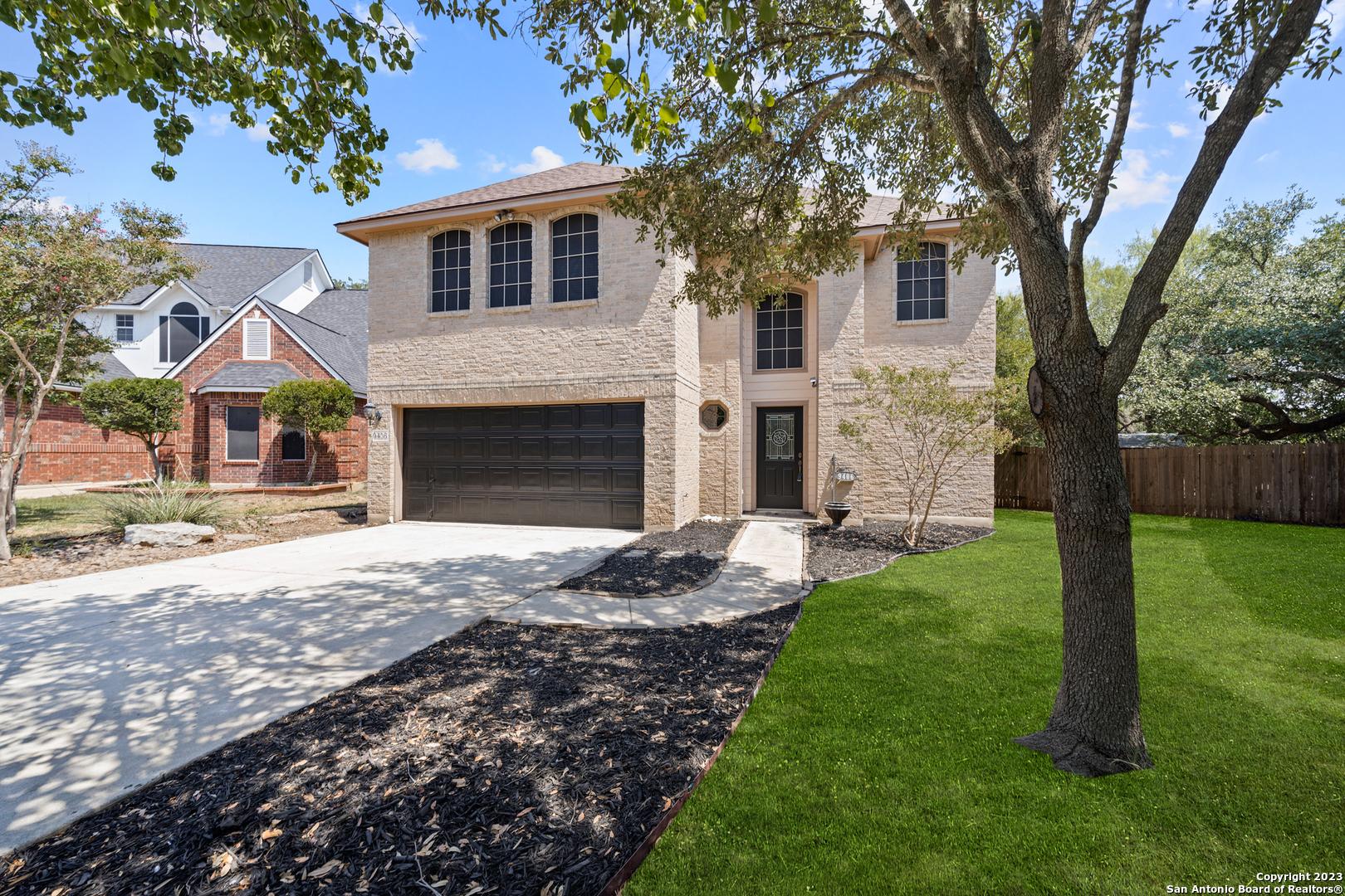 a front view of a house with a garden and yard