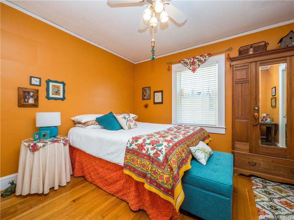 2412 Laburnum Avenue Charlotte, NC 28205 - Photo 11 of 24 a bedroom with a bed and a chandelier