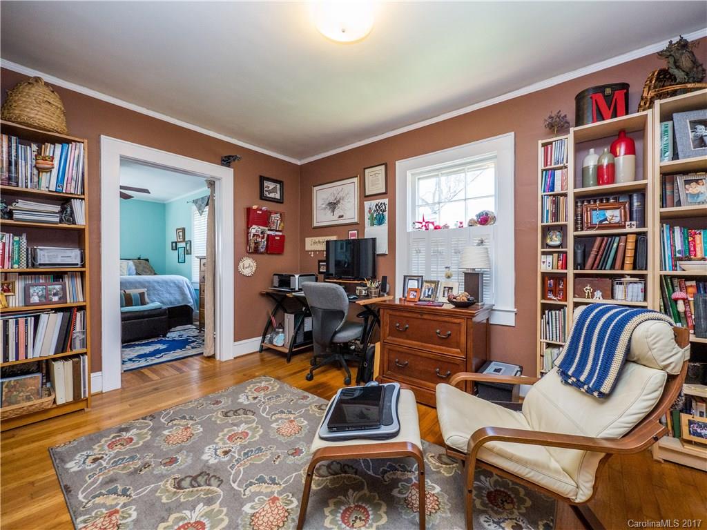 2412 Laburnum Avenue Charlotte, NC 28205 - Photo 15 of 24 a living room with furniture and a book shelf