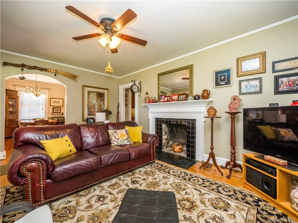 2412 Laburnum Avenue Charlotte, NC 28205 - Photo 6 of 24 a living room with furniture a flat screen tv and a fireplace