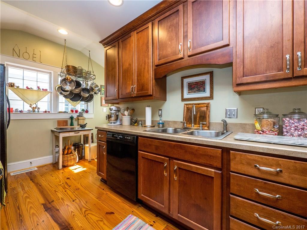 2412 Laburnum Avenue Charlotte, NC 28205 - Photo 8 of 24 a kitchen with stainless steel appliances granite countertop wooden cabinets and a stove top oven