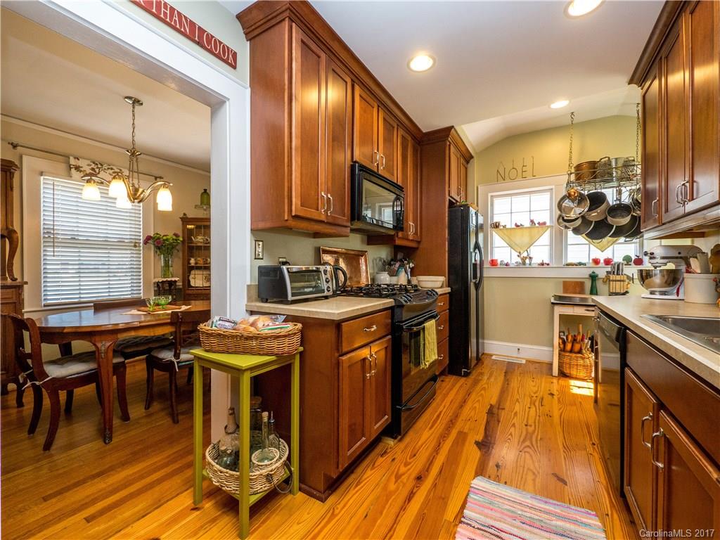 2412 Laburnum Avenue Charlotte, NC 28205 - Photo 9 of 24 a kitchen with stainless steel appliances granite countertop a stove a sink and a refrigerator