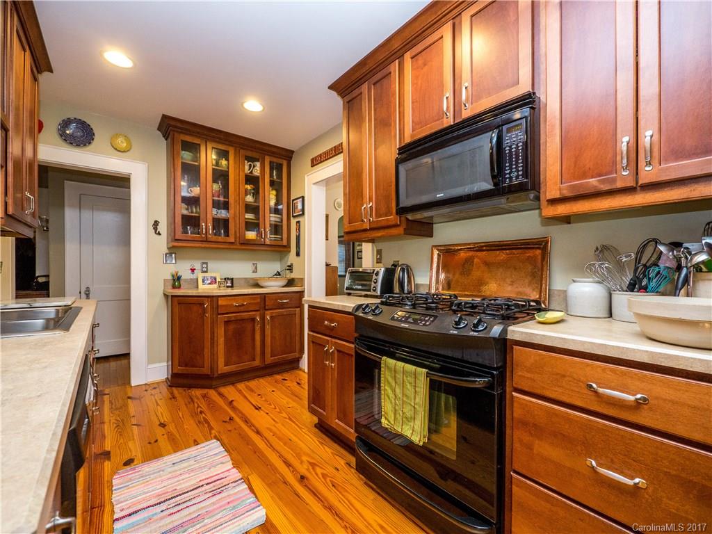 2412 Laburnum Avenue Charlotte, NC 28205 - Photo 10 of 24 a kitchen with stainless steel appliances granite countertop a stove and a microwave