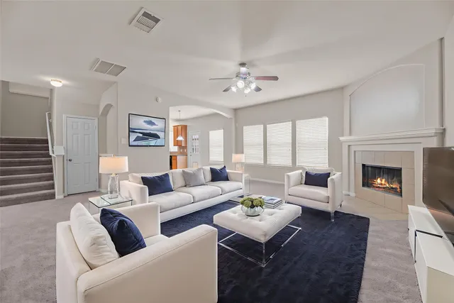 a living room with furniture fireplace and a table