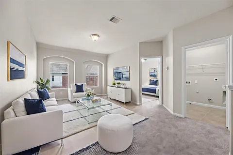 a living room with furniture and a large window