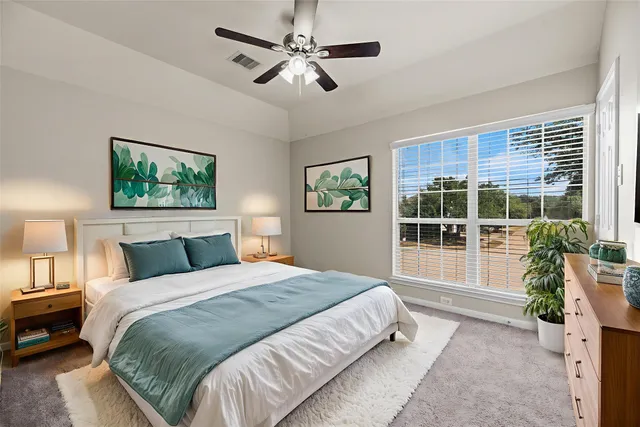 a spacious bedroom with a large bed and a window