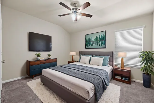 a bedroom with a bed and a flat screen tv