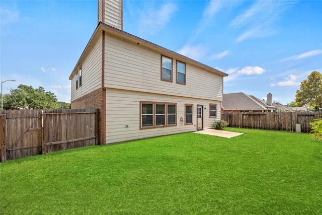 a backyard of a house with wooden fence