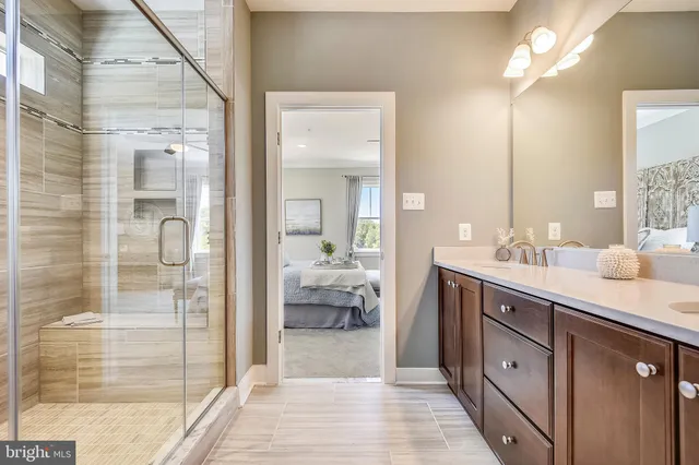a spacious bathroom with a shower sink and mirror