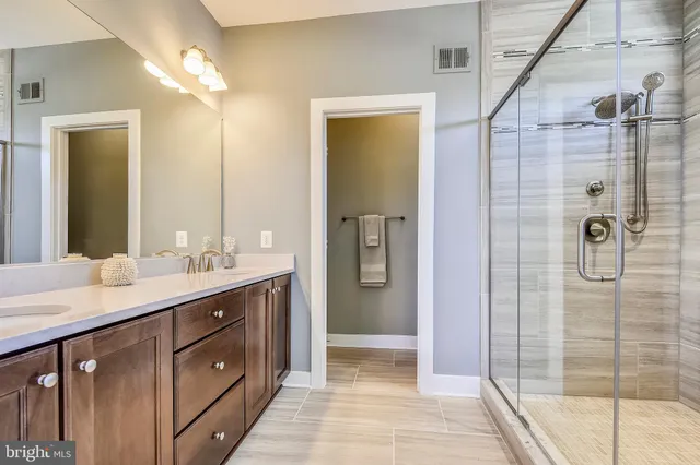 a spacious bedroom with a bed and a chandelier