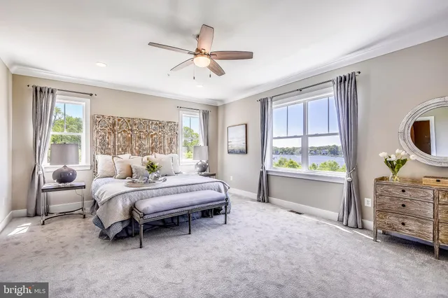 a spacious bedroom with a bed and ceiling fan