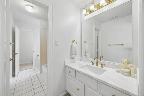 a bathroom with a sink vanity granite and a mirror