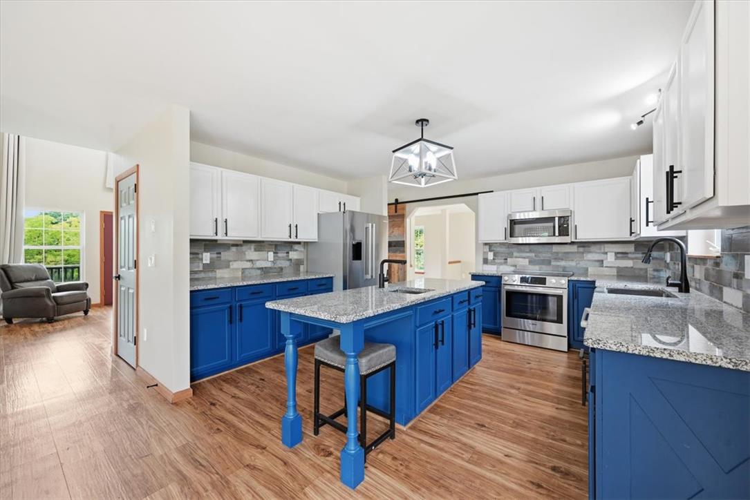 387 Blue Ridge Road Saylorsburg, PA 18353 - Photo 21 of 90 A well-appointed kitchen features a large island with seating and stainless steel appliances.