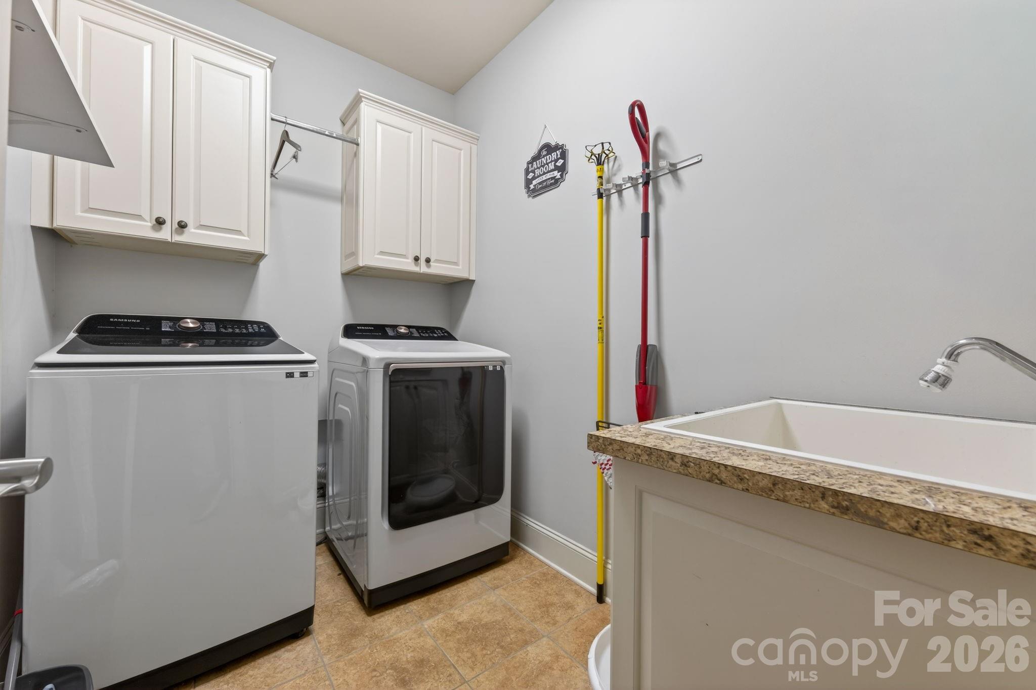 3138 Rappahannock Court, Unit 16 Matthews, NC 28104 - Photo 35 of 38 a utility room with sink dryer and washer