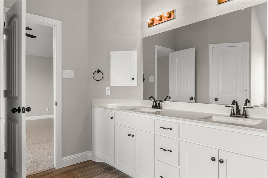 314 Pennington Road Josephine, TX 75173 - Photo 15 of 37 a bathroom with a granite countertop sink and a mirror