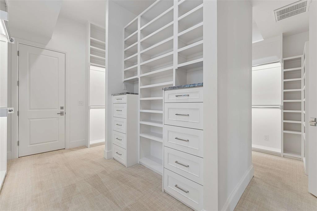 7110 Robin Road Dallas, TX 75209 - Photo 20 of 36 a view of walk in closet and empty racks