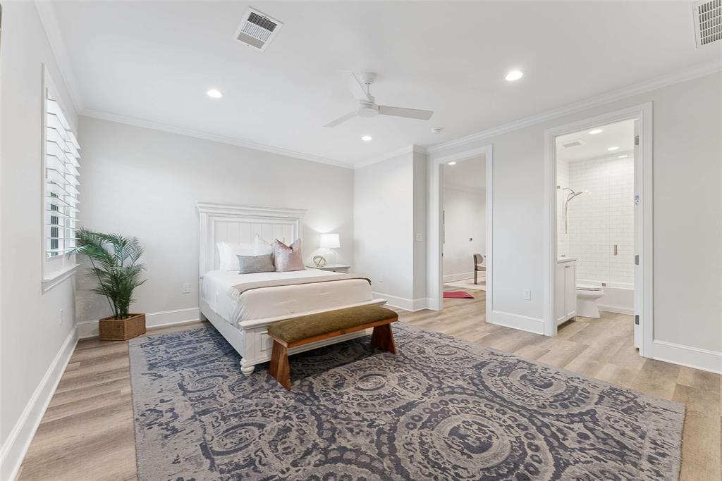 7110 Robin Road Dallas, TX 75209 - Photo 30 of 36 a spacious bedroom with a bed and a potted plant