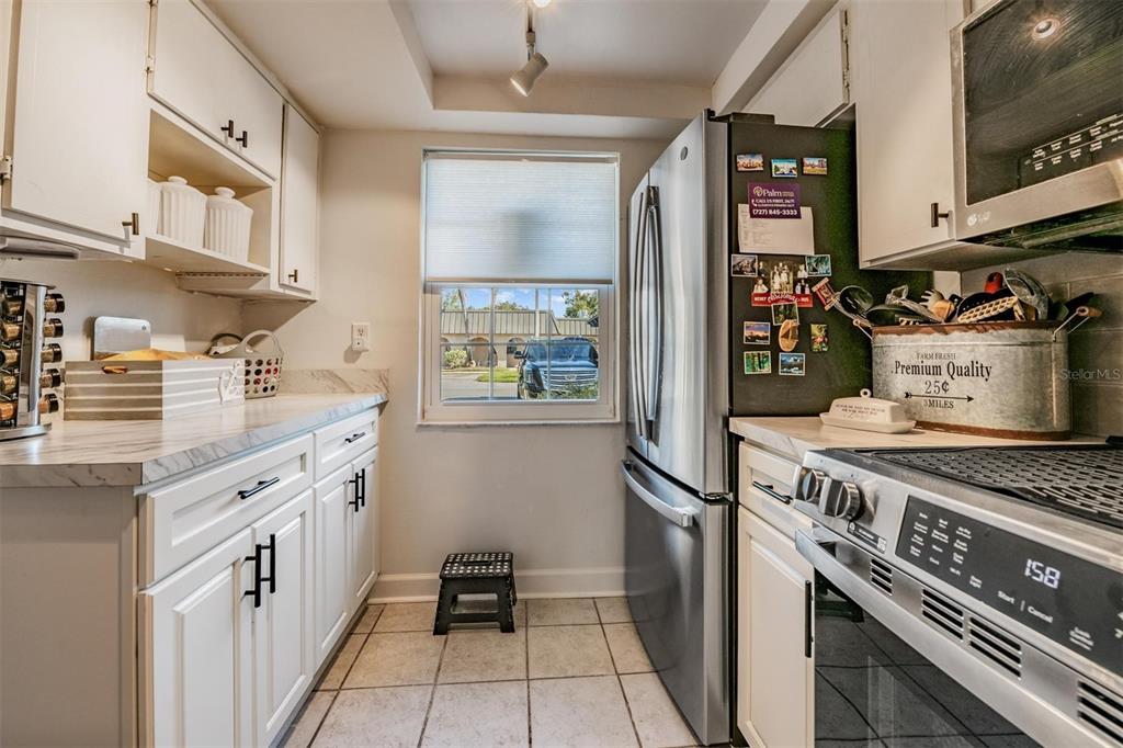 4450 Sunstate Drive New Port Richey, FL 34652 - Photo 11 of 29 a kitchen with stainless steel appliances granite countertop a stove and a refrigerator