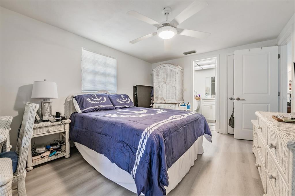 4450 Sunstate Drive New Port Richey, FL 34652 - Photo 14 of 29 a bedroom with a bed and a chandelier