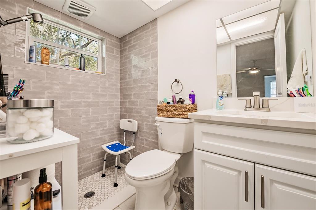 4450 Sunstate Drive New Port Richey, FL 34652 - Photo 15 of 29 a bathroom with a toilet sink and mirror