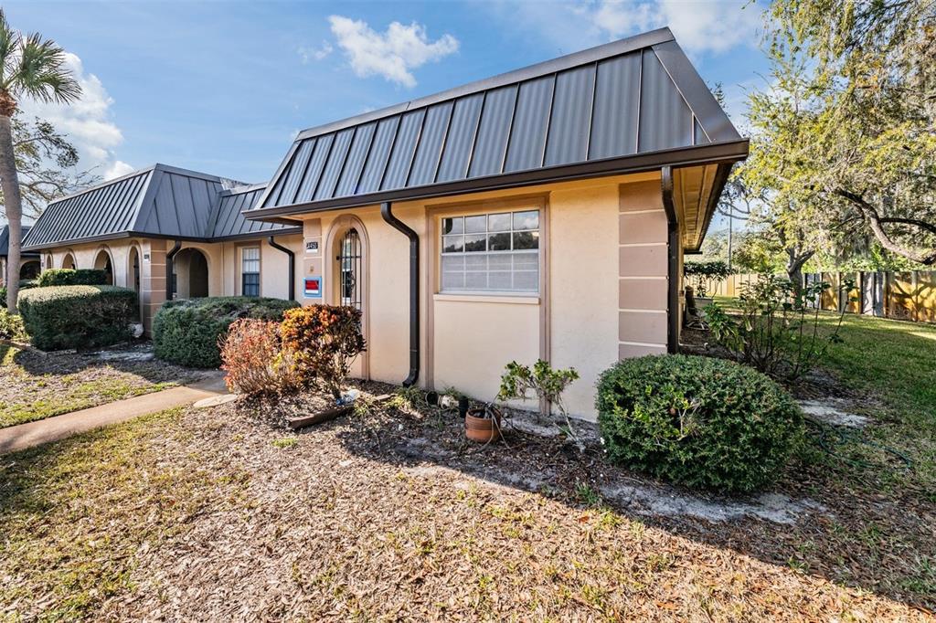 4450 Sunstate Drive New Port Richey, FL 34652 - Photo 29 of 29 a front view of a house with garden