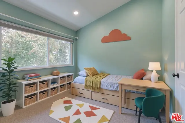 a bedroom with furniture and a window