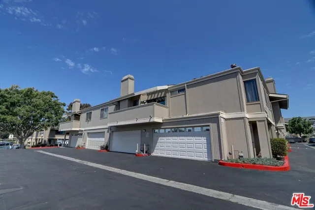a view of street along with house and trees