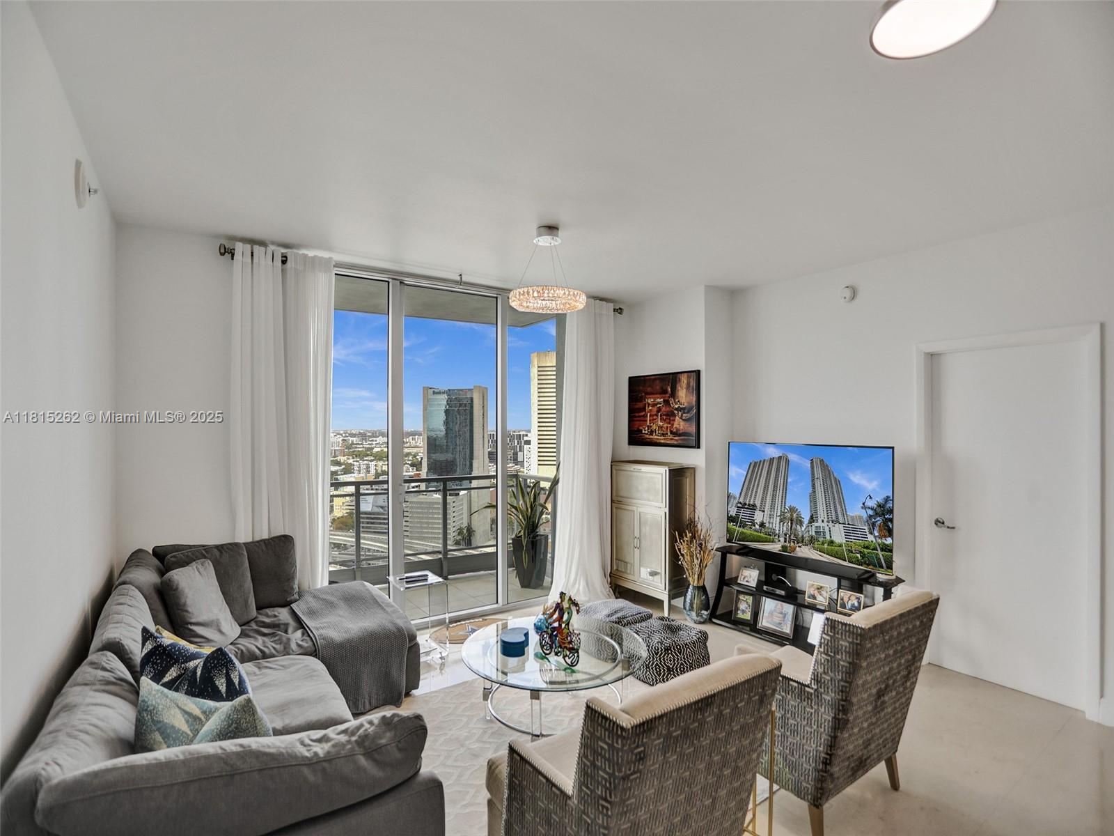 90 Southwest 3rd Street, Unit 2809 Miami, FL 33130 - Photo 13 of 67 a living room with furniture and a flat screen tv
