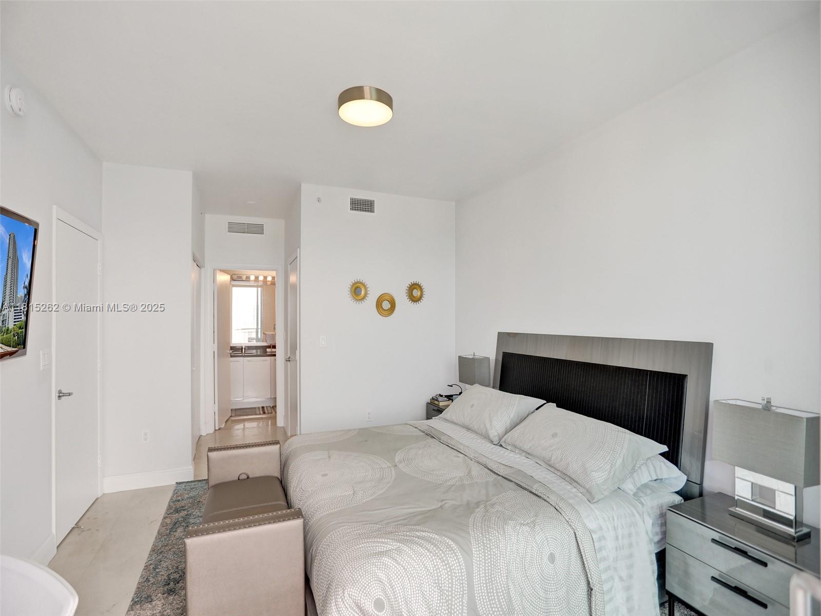 90 Southwest 3rd Street, Unit 2809 Miami, FL 33130 - Photo 16 of 67 a bedroom with a bed and a lamp