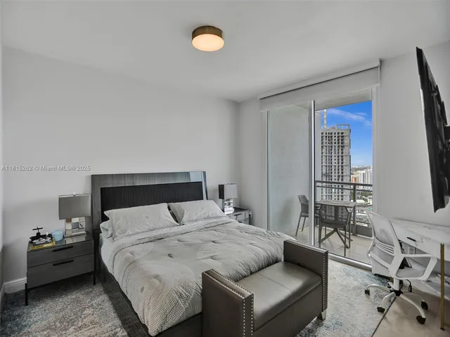 a bedroom with a bed a desk and chair