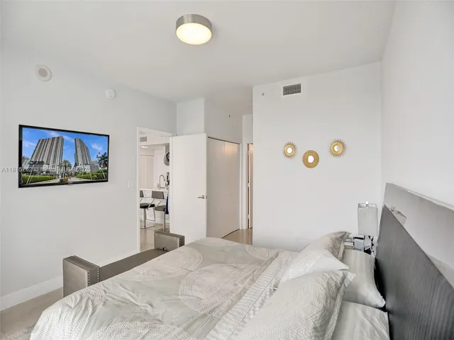 a bathroom with a granite countertop sink and a mirror with toilet