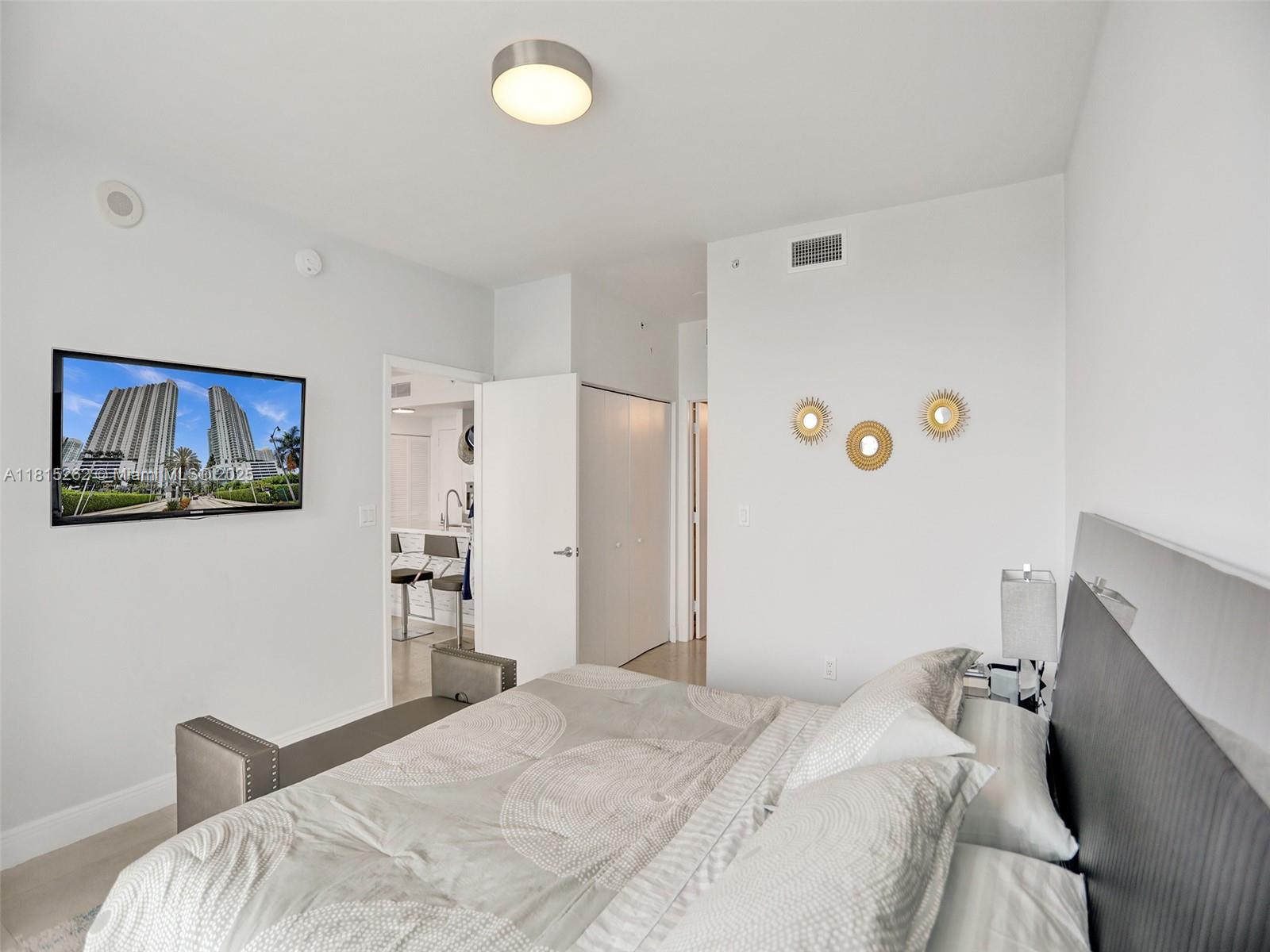 90 Southwest 3rd Street, Unit 2809 Miami, FL 33130 - Photo 18 of 67 a bedroom with a bed and a cabinets