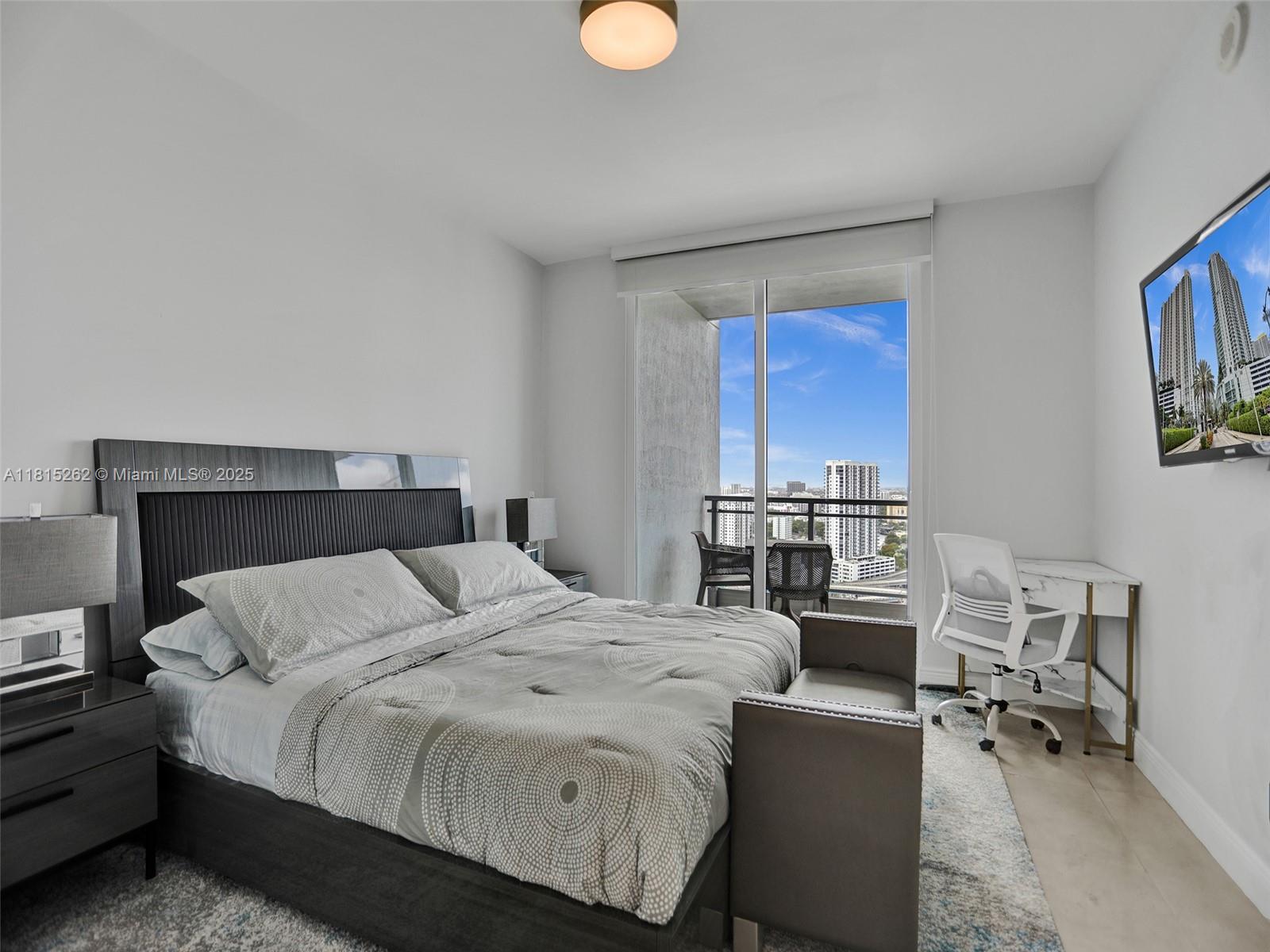 90 Southwest 3rd Street, Unit 2809 Miami, FL 33130 - Photo 19 of 67 a bedroom with a bed a desk and chair