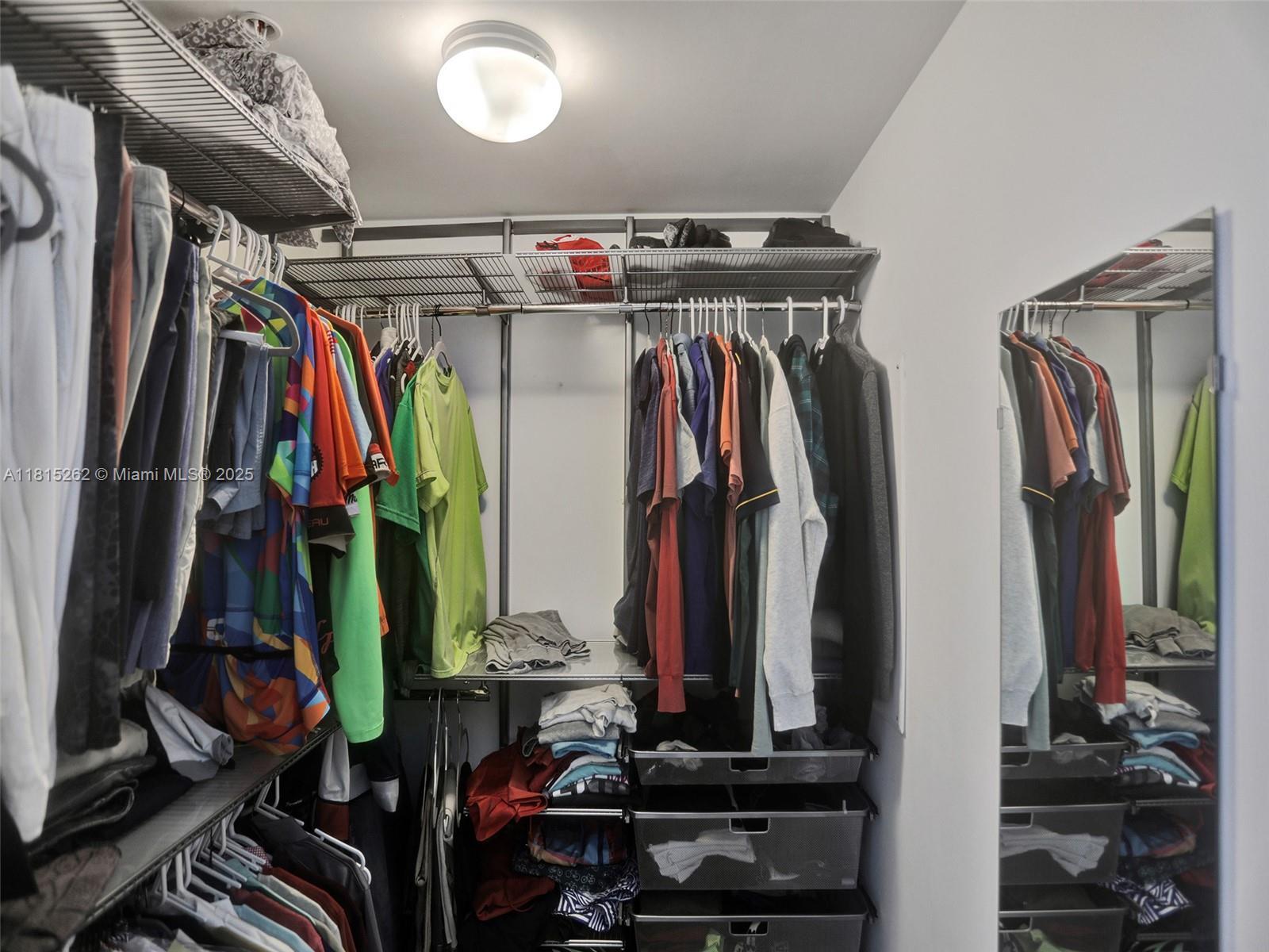 90 Southwest 3rd Street, Unit 2809 Miami, FL 33130 - Photo 37 of 67 a view of walk in closet with clothes and shoes