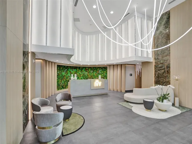 a dining room with furniture and a floor to ceiling window