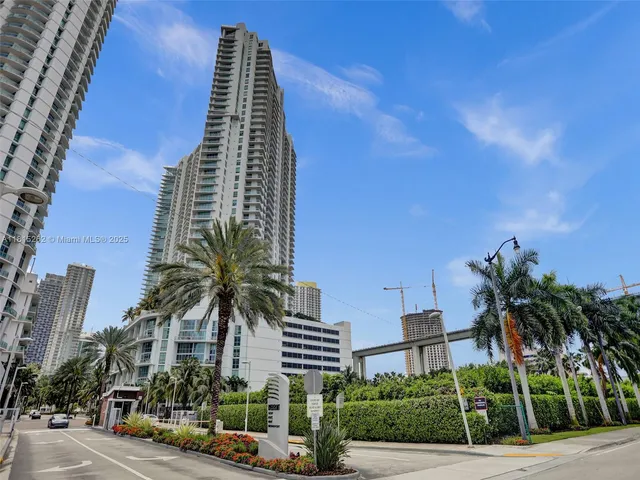 a kitchen with stainless steel appliances granite countertop a sink and a refrigerator
