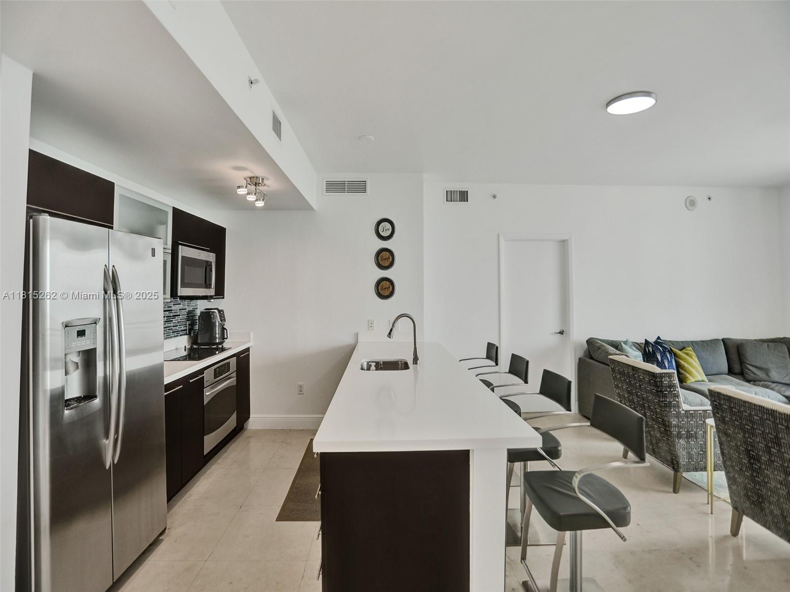 90 Southwest 3rd Street, Unit 2809 Miami, FL 33130 - Photo 7 of 67 a kitchen with stainless steel appliances a refrigerator sink and stove