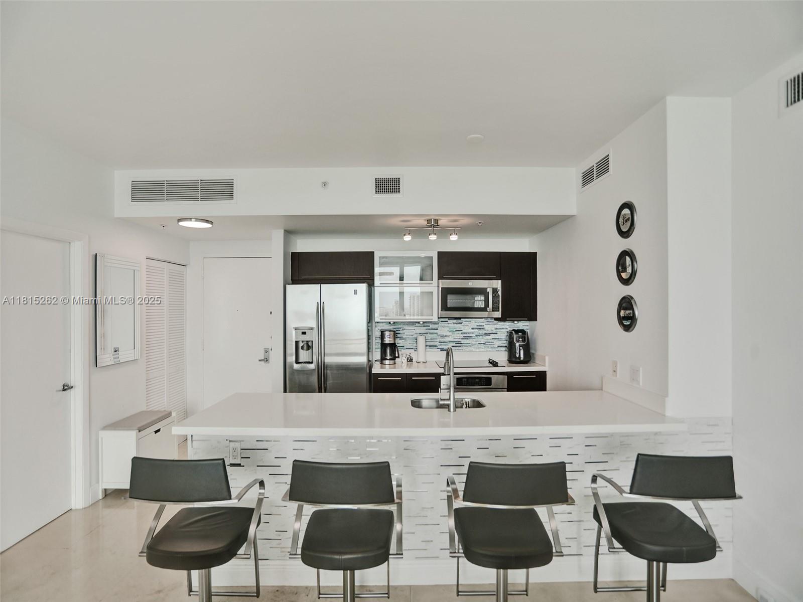 90 Southwest 3rd Street, Unit 2809 Miami, FL 33130 - Photo 8 of 67 a room with stainless steel appliances kitchen island granite countertop a view of living room