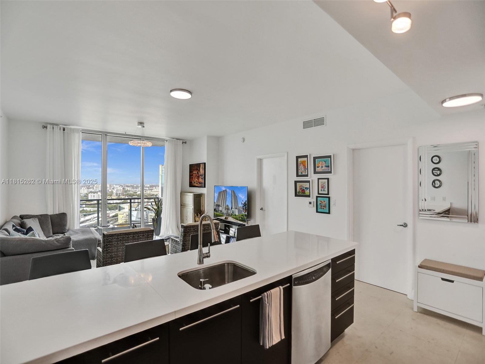 90 Southwest 3rd Street, Unit 2809 Miami, FL 33130 - Photo 9 of 67 a kitchen with stainless steel appliances a sink stove and cabinets