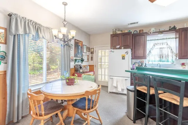 a dining room with furniture and window