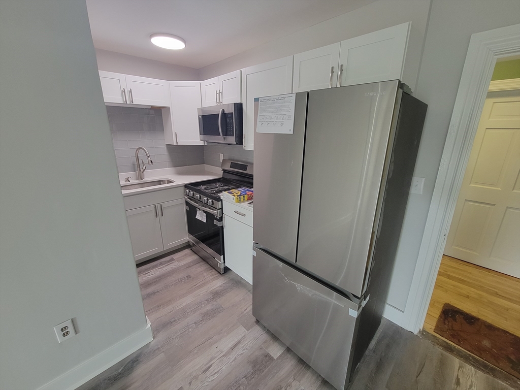 7 High Street, Unit 11 Clinton, MA 01510 - Photo 6 of 17 a kitchen with stainless steel appliances a refrigerator and a stove top oven