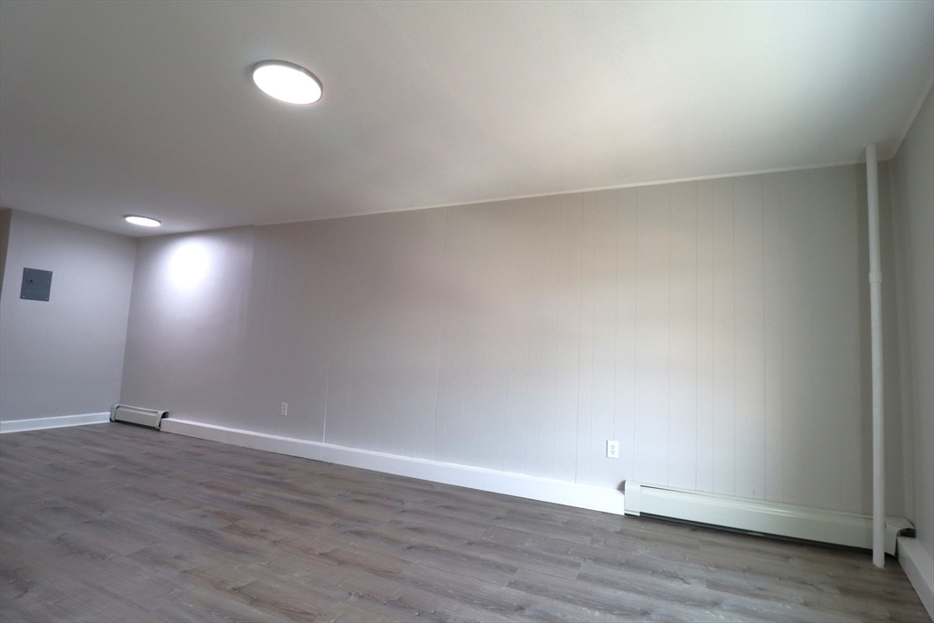 7 High Street, Unit 11 Clinton, MA 01510 - Photo 8 of 17 an empty room with wooden floor and windows