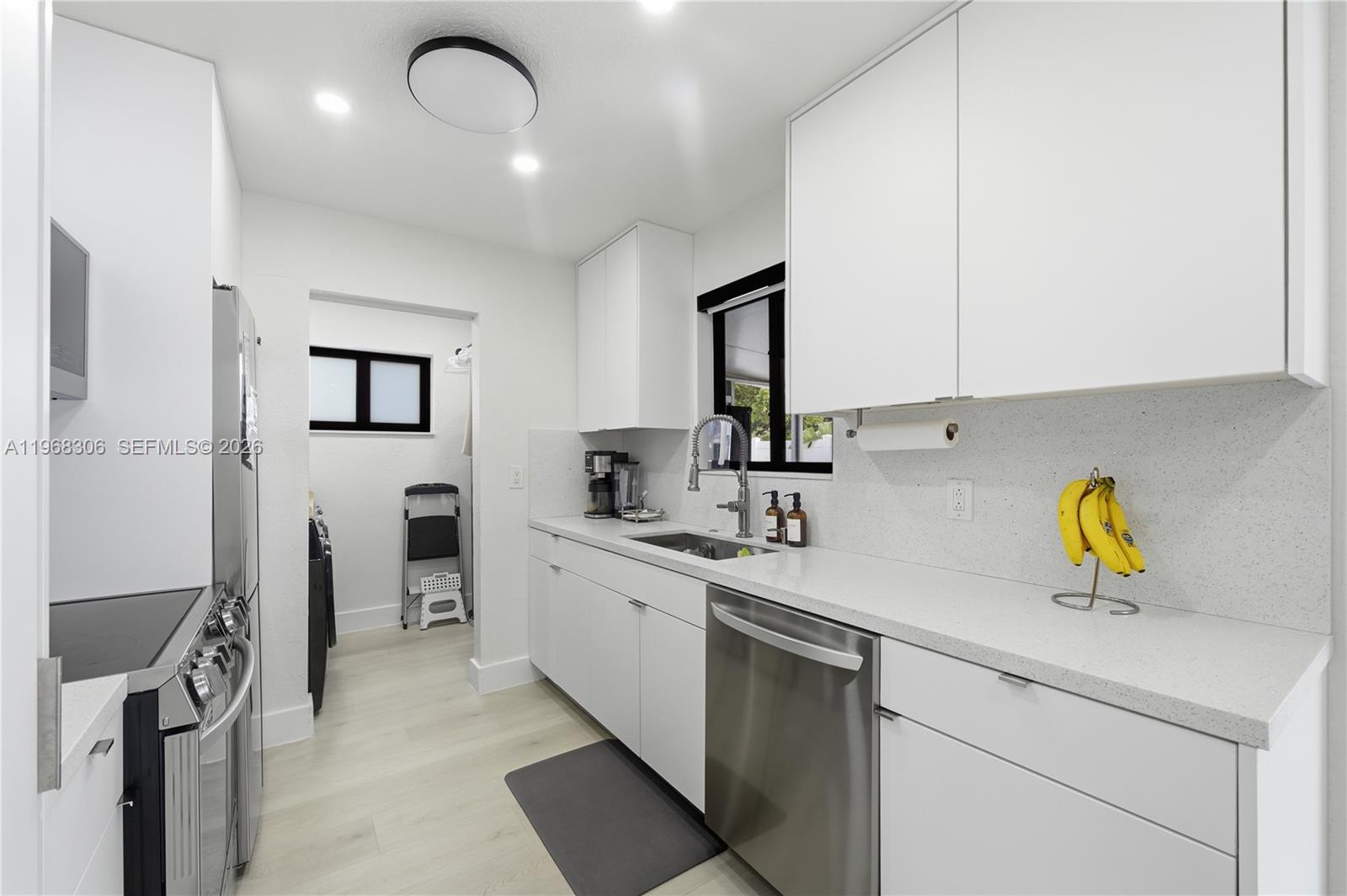 7491 Raleigh Street Hollywood, FL 33024 - Photo 12 of 28 a kitchen with a sink stainless steel appliances and cabinets