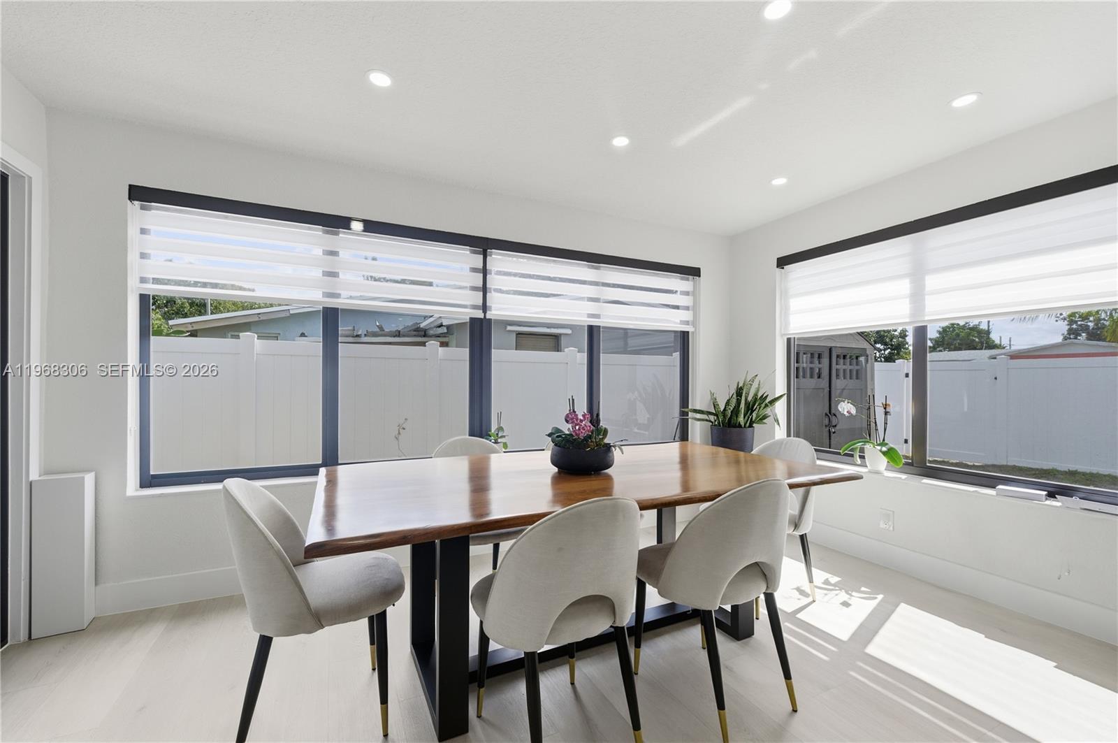 7491 Raleigh Street Hollywood, FL 33024 - Photo 16 of 28 a view of a dining room with furniture large windows and wooden floor