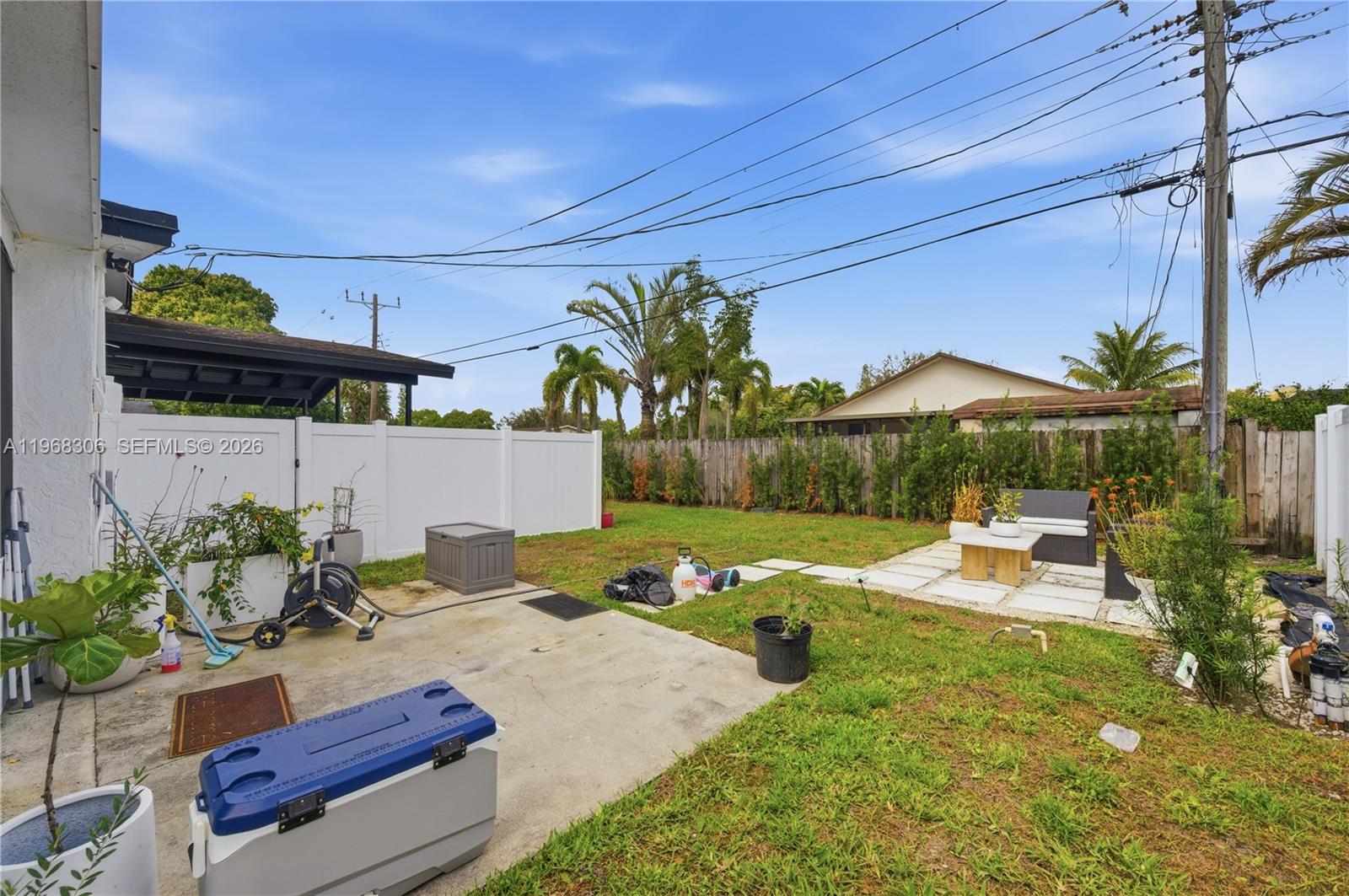 7491 Raleigh Street Hollywood, FL 33024 - Photo 17 of 28 a backyard of a house with table and chairs